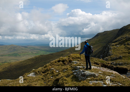 A walker in the ridge of the Sheeffry Mountains, County Mayo, Ireland Stock Photo