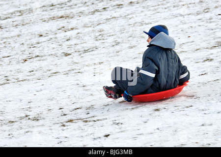 Boy Sledding Down Hill in Cherokee Park in Louisville, Kentucky Stock Photo