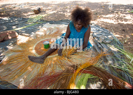Aboriginal woman weaving a traditional pandanus mat in Arnhem Land ...
