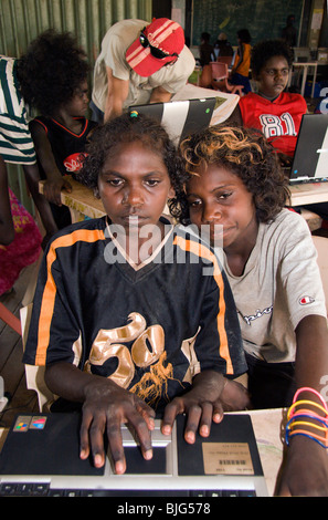 Aboriginal teenagers are intrigued learning to work on computers at Gamardi outstation school near Maningrida, Stock Photo