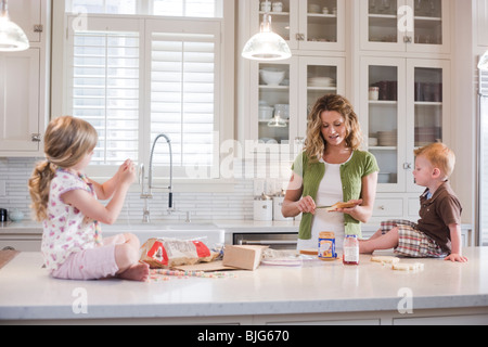 mother and children in the kitchen Stock Photo