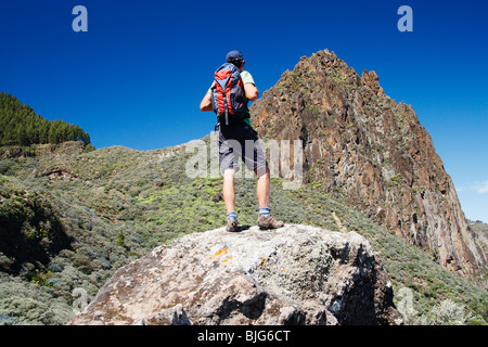 Male hiker with small rucksack hiking near Tenteniguada on Gran Canaria in The Canary islands Stock Photo