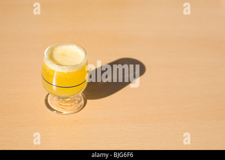 A glass of Poncha stands on a table on the island of Madeira, Portugal. Stock Photo