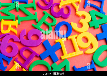 object on red - toy plastic letters and numbers Stock Photo