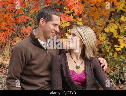 attractive young couple close and looking at each other in autumn Stock Photo