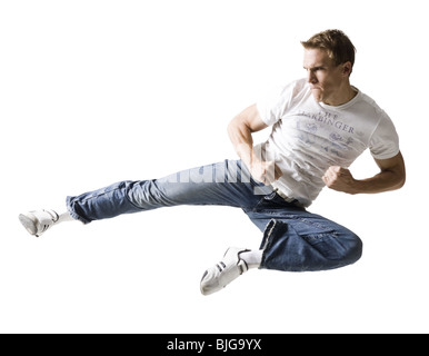man doing a karate kick Stock Photo