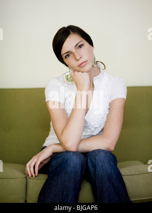 woman sitting on a sofa Stock Photo