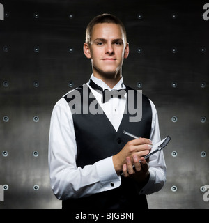 man in a tuxedo taking notes Stock Photo