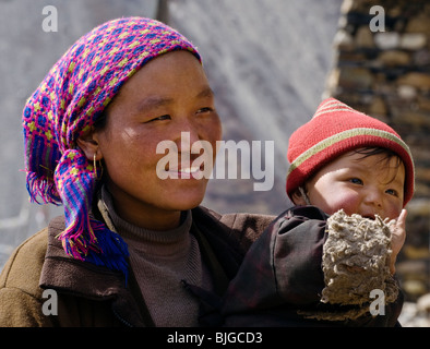 MOTHER and CHILD in the village of SAMDO on the AROUND MANASLU TREK - NUPRI REGION, NEPAL Stock Photo