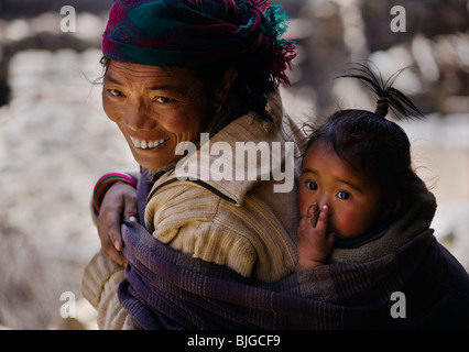 MOTHER and CHILD in the village of SAMDO on the AROUND MANASLU TREK - NUPRI REGION, NEPAL Stock Photo