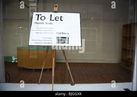 An empty office shop store to let sign in the centre of Cardiff Wales UK Stock Photo