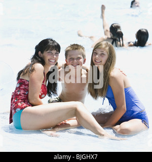 mother and two children at a waterpark Stock Photo