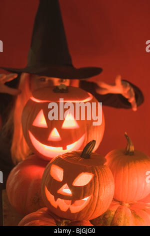 Pumpkin lanterns and witch for Halloween - Stock Photo