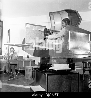 Flight training in 1950s. Pilot learning to fly a plane in an aircraft stimulator. Stock Photo