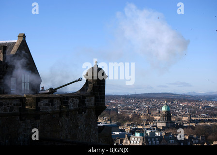 Firing the One O'clock Gun at Edinburgh Castle with pieces of wadding from the blank shell hanging in the air. Stock Photo