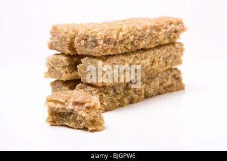 Flapjack oat cake biscuit stack isolated against white background. Stock Photo