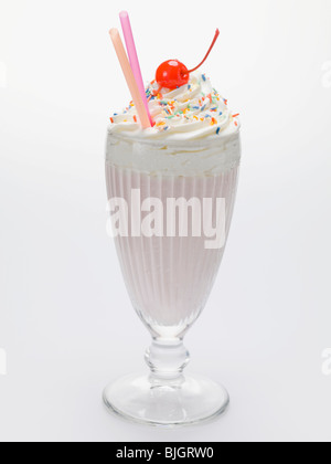 Milkshake with cream, sprinkles and cocktail cherry - Stock Photo