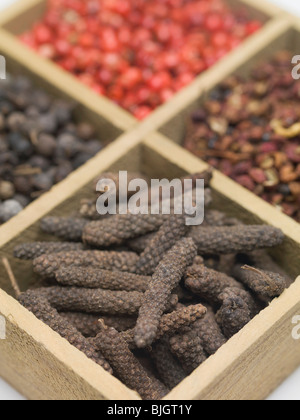 Spices and dried berries in wooden container - Stock Photo