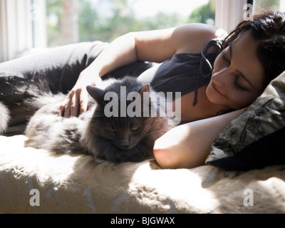 woman on a window bench with her cat Stock Photo