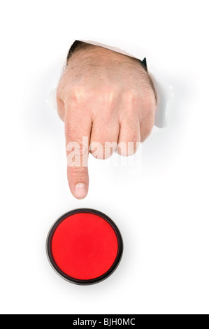 A hand with index finger extended pokes through torn paper prepares to push the panic stop button. Stock Photo