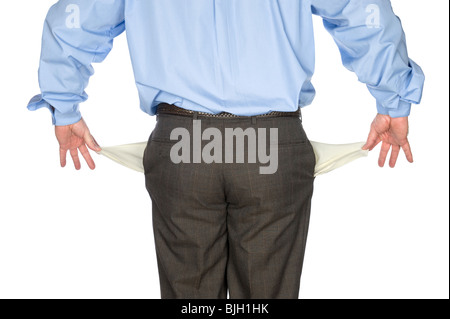 A businessman holds out his empty pockets showing he is broke and has no cash. Stock Photo