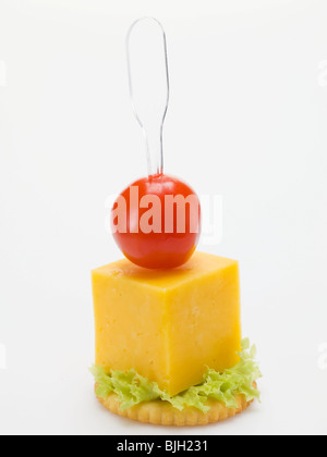 Cheese and cherry tomato on cracker - Stock Photo