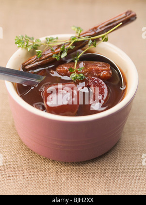 Spiced plum sauce with cinnamon and thyme - Stock Photo