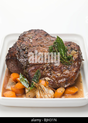 Boned leg of wild boar with carrots - Stock Photo