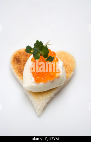 Canapé: sour cream and keta caviar on toast - Stock Photo