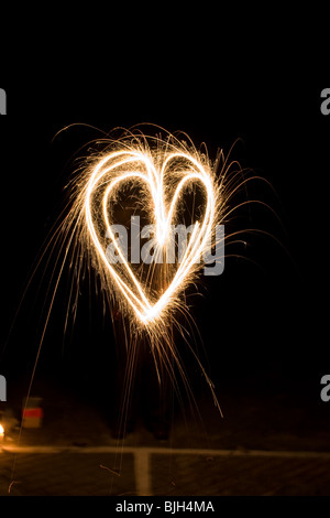 A heart shape drawn with a burning sparkler Stock Photo