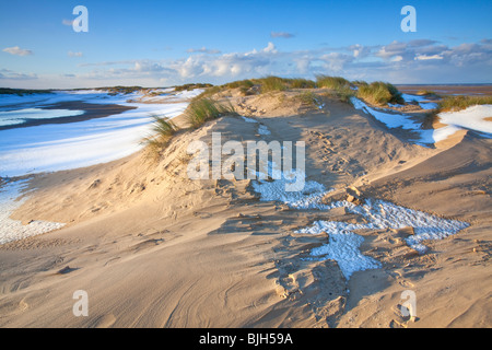 Winter snow on the beach and sand dunes at Holkham Bay on the North Norfolk Coast. Stock Photo