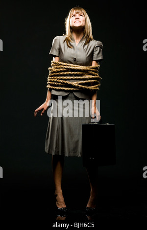 businesswoman all tied up with ropes Stock Photo