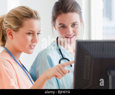 Nurses looking at computer Stock Photo