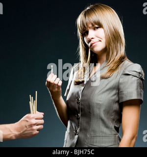 businesswoman drawing straws Stock Photo