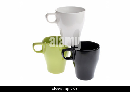 Three coffee cups, one standing on top of two others, isolated on white Stock Photo