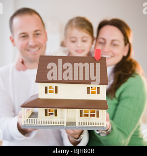 Family holding model house Stock Photo