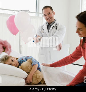 Young girl in hospital bed Stock Photo