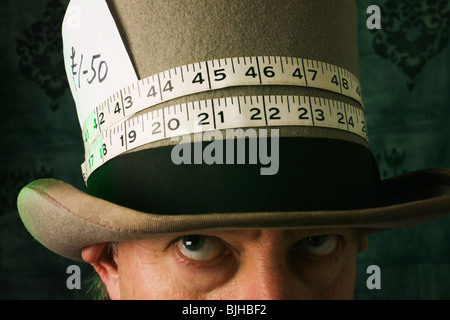 A 'mad hatter' with tape measure around his hat. Stock Photo