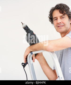 Man holding a drill Stock Photo