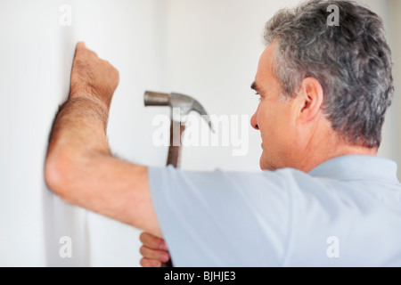 Man using a hammer Stock Photo