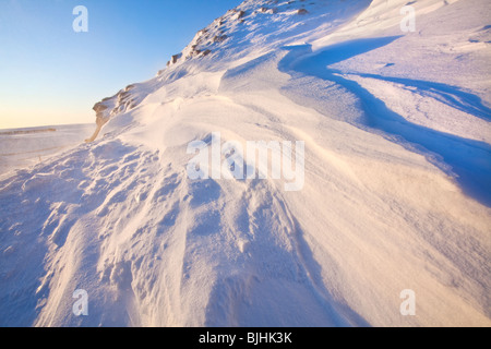 Snow drift formations on the rudge at Rushup Edge in the Peak District National Park following heavy winter snowfall Stock Photo