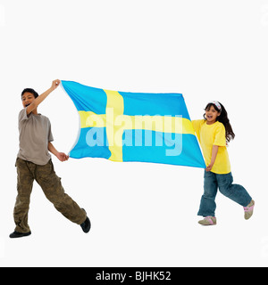Children carrying flag Stock Photo