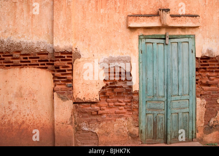 The wall and doors of an old French-era building in Savannakhet, Lao People's Democratic Republic. Stock Photo