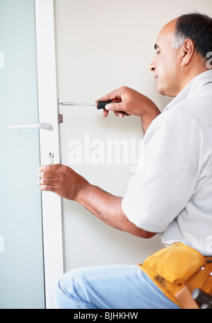 Man fixing door Stock Photo