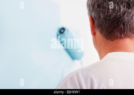 Man painting wall Stock Photo