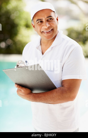 Tradesman writing on clipboard Stock Photo