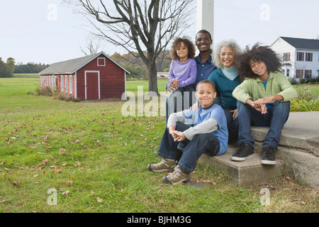 Family sitting on porch Stock Photo