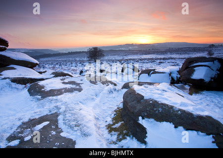 Sunset from a snowy Owler Tor in the Peak District National Park Stock Photo