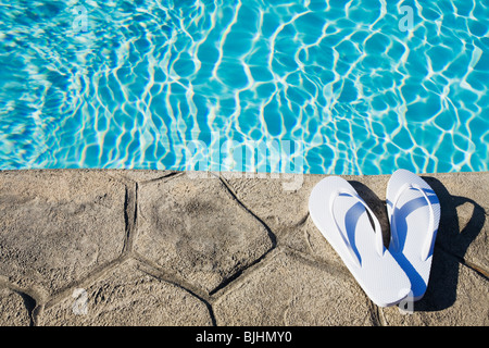 Flip flops by the pool Stock Photo