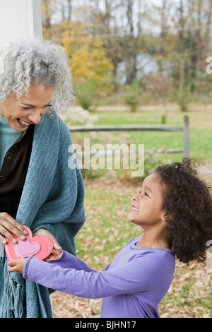Girl giving Valentine's card to woman Stock Photo